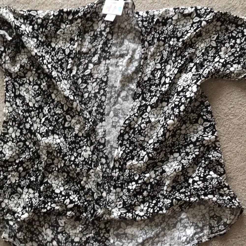 Girl Lularoe black back ground white flowers